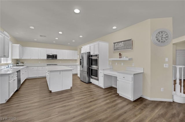 3217 Bonassola Ave, North Las Vegas, NV 89031 - kitchen featuring stainless steel appliances, a sink, white cabinets, a kitchen island, and recessed lighting