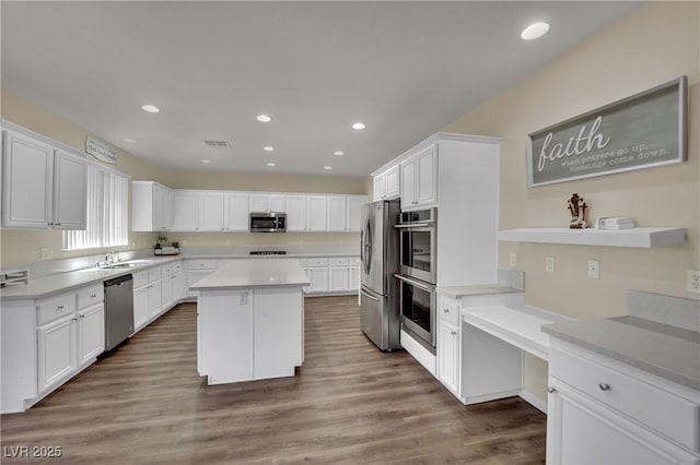 3217 Bonassola Ave, North Las Vegas, NV 89031 - kitchen featuring appliances with stainless steel finishes, a sink, white cabinetry, a center island, and recessed lighting