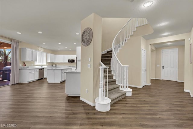 3217 Bonassola Ave, North Las Vegas, NV 89031 - kitchen featuring appliances with stainless steel finishes, dark wood-style floors, white cabinets, and recessed lighting
