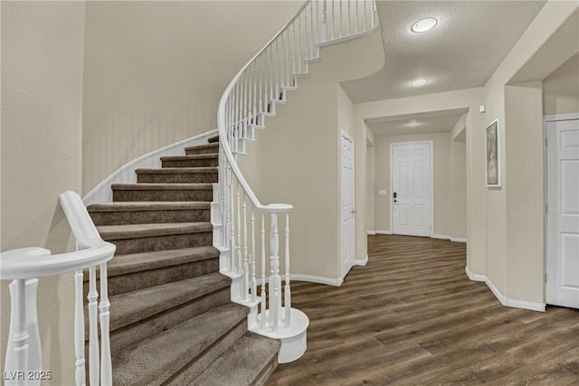 3217 Bonassola Ave, North Las Vegas, NV 89031 - stairway with wood finished floors, baseboards, and a textured ceiling