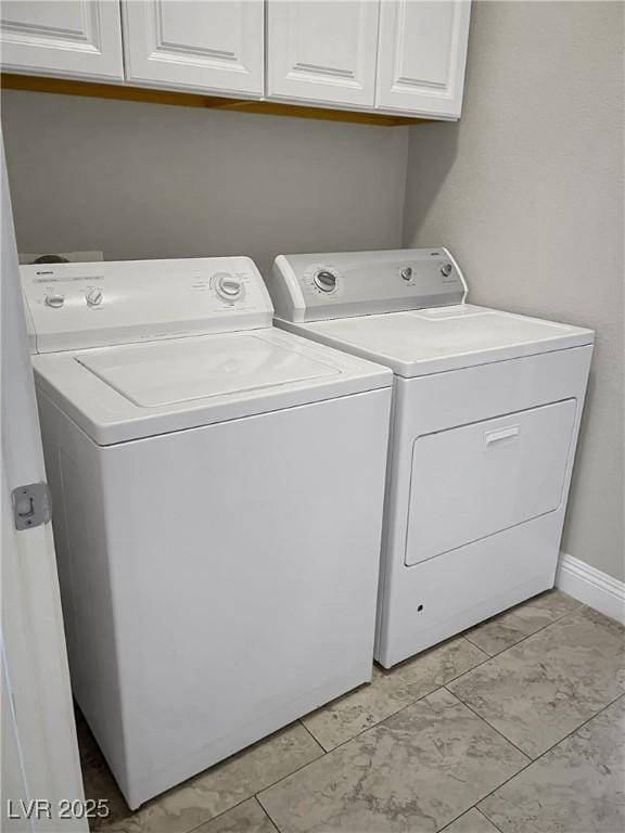 3217 Bonassola Ave, North Las Vegas, NV 89031 - laundry area featuring separate washer and dryer, cabinet space, baseboards, and light marble finish floors
