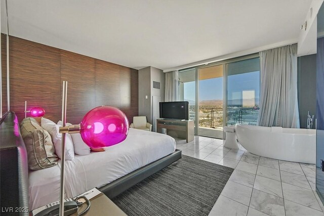 4381 W Flamingo Rd Unit 1101, Las Vegas, NV 89103 - bedroom featuring access to outside, a wall of windows, and light marble finish flooring