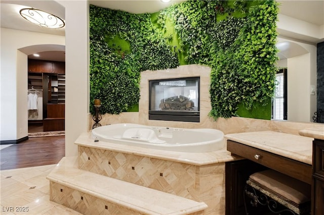 7625 Coley Ave, Las Vegas, NV 89117 - bathroom featuring a garden tub, vanity, and a spacious closet