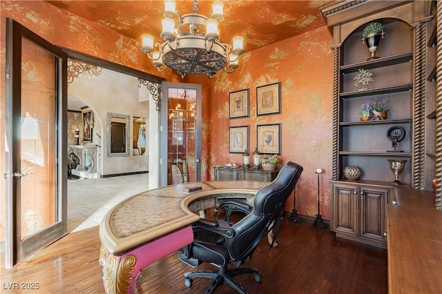 7625 Coley Ave, Las Vegas, NV 89117 - office area featuring a chandelier, hardwood / wood-style floors, a textured wall, and baseboards
