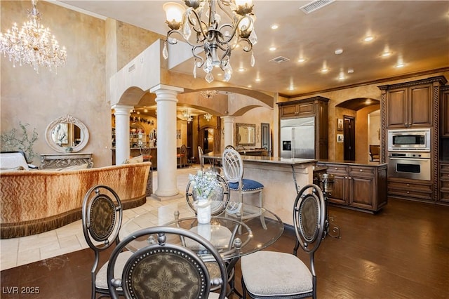 7625 Coley Ave, Las Vegas, NV 89117 - dining room featuring ornate columns, a chandelier, arched walkways, recessed lighting, and crown molding