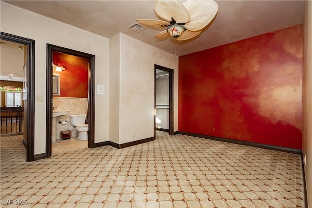 7625 Coley Ave, Las Vegas, NV 89117 - unfurnished room featuring baseboards, ceiling fan, and an accent wall