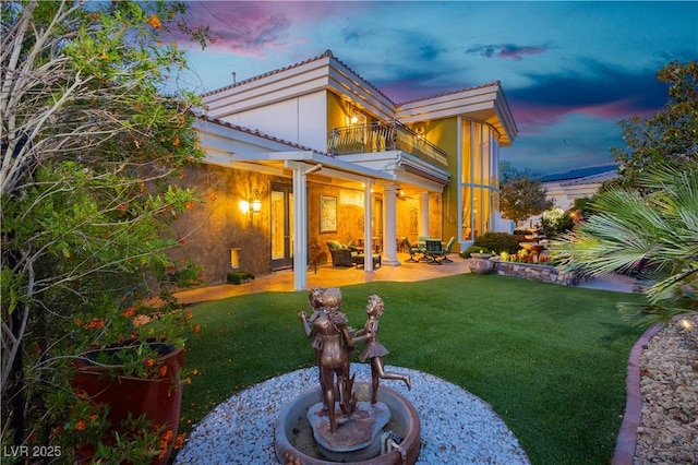 7625 Coley Ave, Las Vegas, NV 89117 - back of property featuring a balcony, a lawn, and a patio