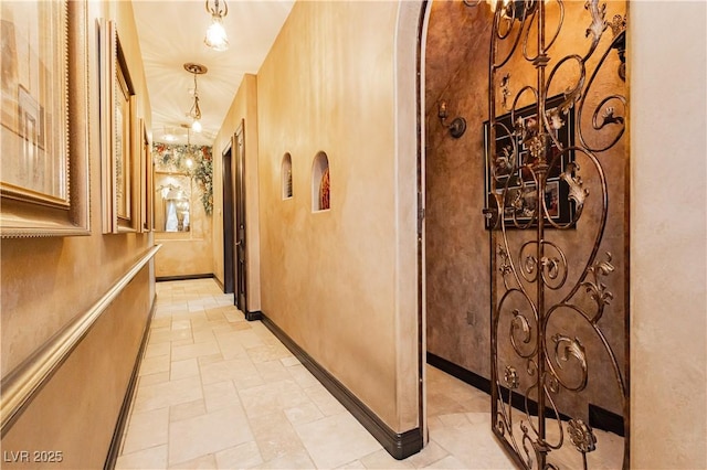 7625 Coley Ave, Las Vegas, NV 89117 - hall featuring baseboards and a chandelier