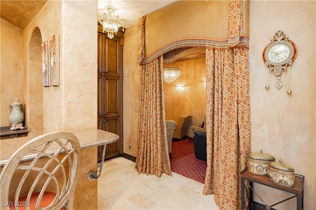 7625 Coley Ave, Las Vegas, NV 89117 - bathroom with a textured wall and a chandelier