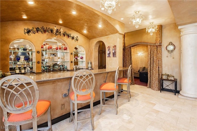 7625 Coley Ave, Las Vegas, NV 89117 - indoor wet bar featuring vaulted ceiling, ornate columns, recessed lighting, and a chandelier