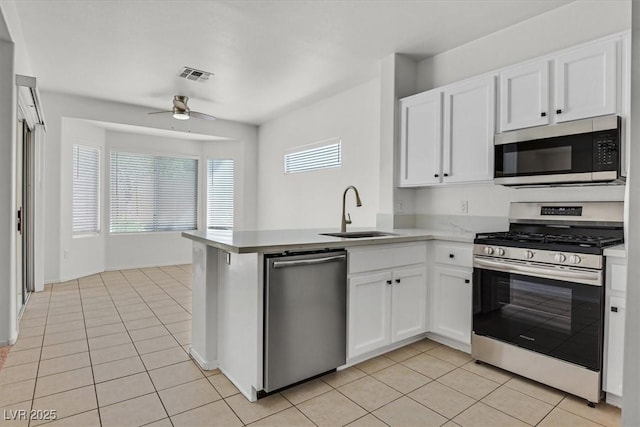 2573 Grandville Ave, Henderson, NV 89052 - kitchen featuring appliances with stainless steel finishes, a sink, a peninsula, ceiling fan, and white cabinets