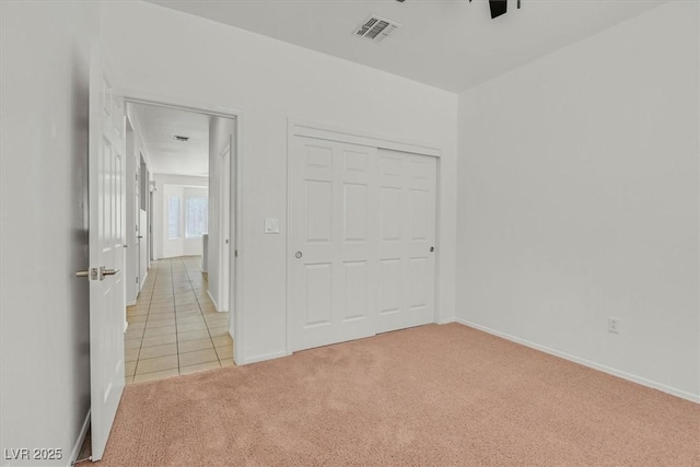 2573 Grandville Ave, Henderson, NV 89052 - unfurnished bedroom with light colored carpet, baseboards, light tile patterned flooring, and a closet