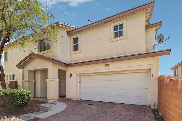 914 Appaloosa Hills Ave, North Las Vegas, NV 89081 - view of front of house featuring an attached garage, stucco siding, fence, and decorative driveway