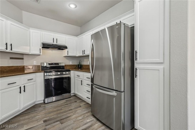914 Appaloosa Hills Ave, North Las Vegas, NV 89081 - kitchen featuring appliances with stainless steel finishes, under cabinet range hood, dark countertops, white cabinets, and recessed lighting