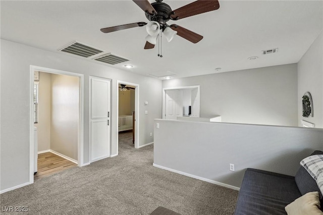 914 Appaloosa Hills Ave, North Las Vegas, NV 89081 - unfurnished room with radiator heating unit, ceiling fan, carpet, an upstairs landing, and baseboards