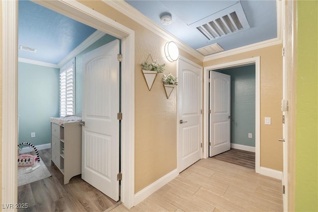 6655 Flaminian Ln Unit 104, North Las Vegas, NV 89084 - hallway featuring ornamental molding, light wood-style floors, and baseboards