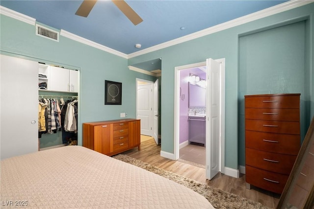 6655 Flaminian Ln Unit 104, North Las Vegas, NV 89084 - bedroom with wood finished floors, a closet, crown molding, a spacious closet, and baseboards