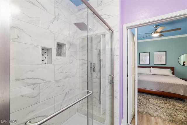 6655 Flaminian Ln Unit 104, North Las Vegas, NV 89084 - ensuite bathroom featuring wood finished floors, a stall shower, ornamental molding, and ceiling fan