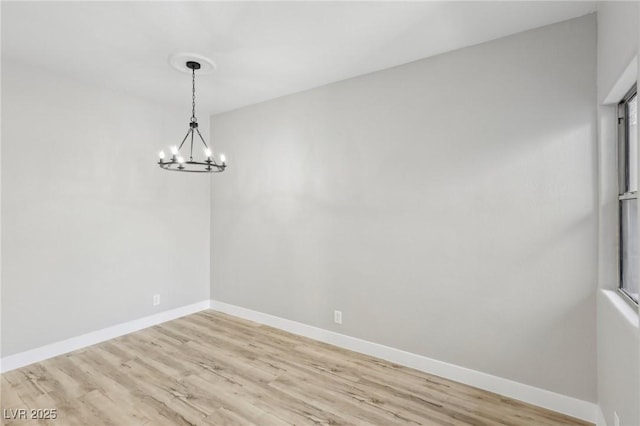 2201 Ramsgate Dr Unit 327, Henderson, NV 89074 - unfurnished dining area featuring a chandelier, light wood-style flooring, and baseboards