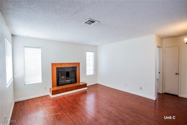 2755 Jennydiane Dr, Las Vegas, NV 89121 - unfurnished living room featuring wood finished floors, a fireplace, baseboards, and a textured ceiling