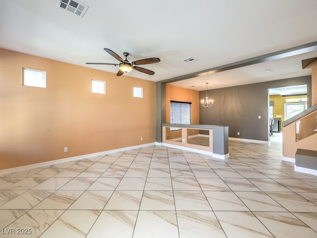 6779 Goose Watch Ct, Las Vegas, NV 89139 - empty room with a chandelier and ceiling fan