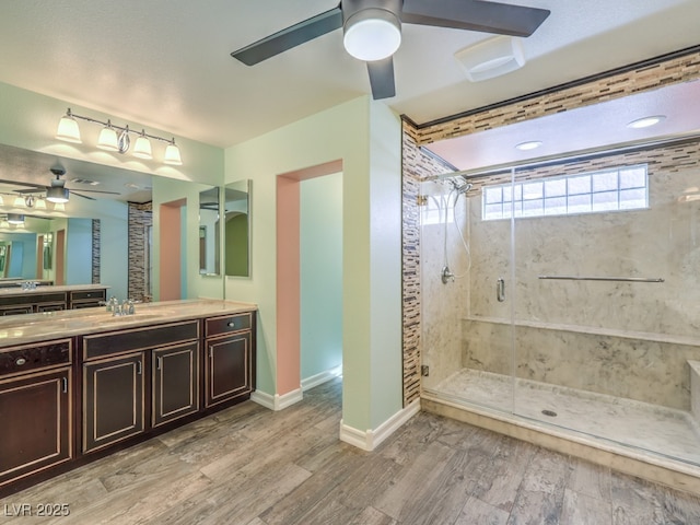 6779 Goose Watch Ct, Las Vegas, NV 89139 - bathroom with ceiling fan, a stall shower, vanity, and wood finished floors
