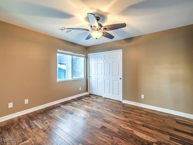 6779 Goose Watch Ct, Las Vegas, NV 89139 - unfurnished bedroom with dark wood-style flooring, a closet, and a ceiling fan