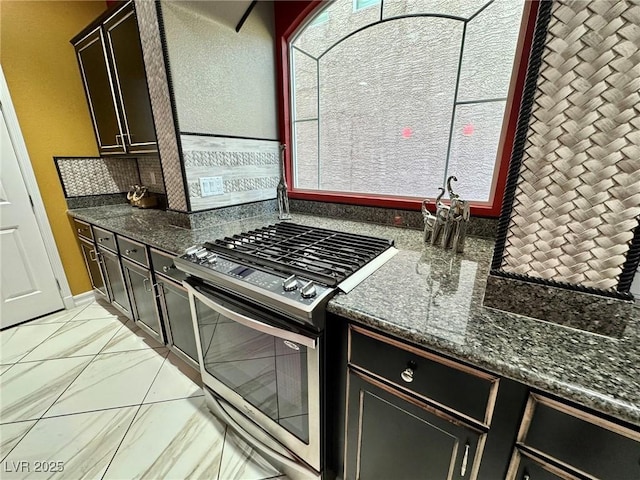 6779 Goose Watch Ct, Las Vegas, NV 89139 - kitchen with stainless steel gas range oven and dark stone counters