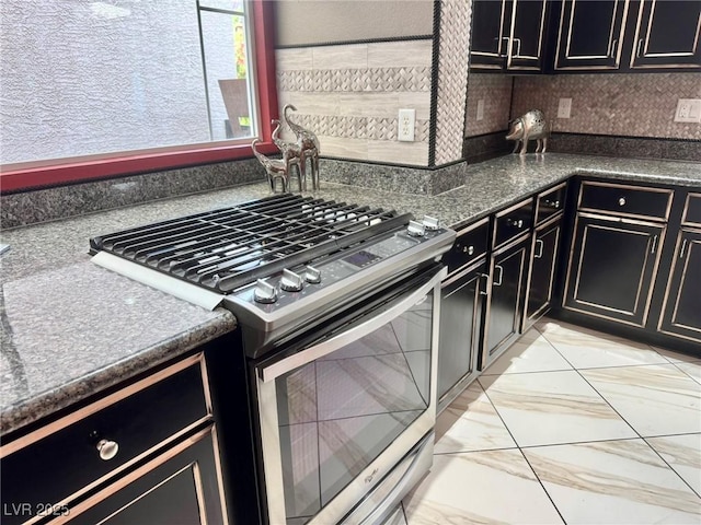6779 Goose Watch Ct, Las Vegas, NV 89139 - kitchen featuring gas range, dark cabinetry, and dark countertops