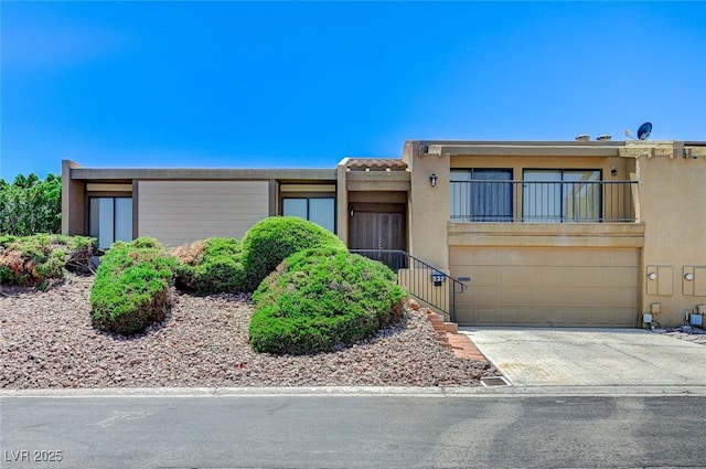 532 Greenbriar Pl, Boulder City, NV 89005 - multi unit property with stucco siding, concrete driveway, a garage, and a balcony