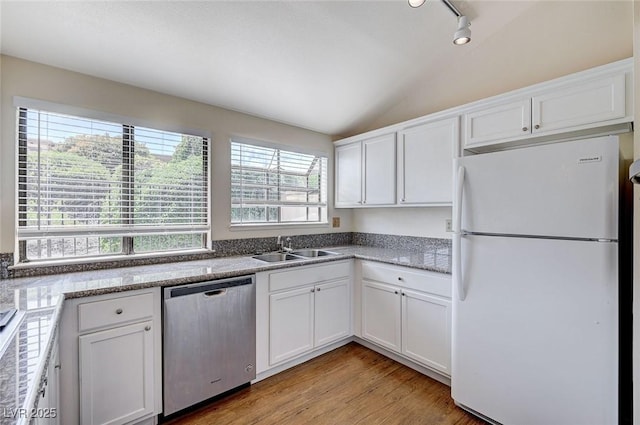 532 Greenbriar Pl, Boulder City, NV 89005 - kitchen with freestanding refrigerator, stainless steel dishwasher, a sink, lofted ceiling, and white cabinets