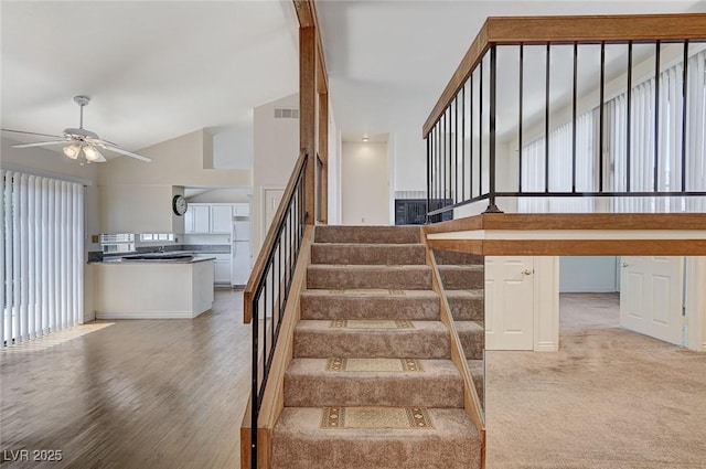 532 Greenbriar Pl, Boulder City, NV 89005 - stairway with ceiling fan, healthy amount of natural light, wood finished floors, and high vaulted ceiling