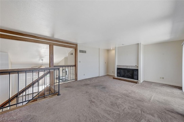 532 Greenbriar Pl, Boulder City, NV 89005 - unfurnished living room with a fireplace with raised hearth, a ceiling fan, carpet flooring, and baseboards