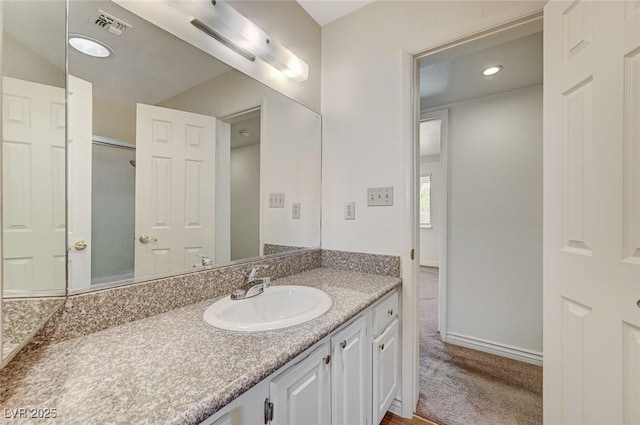 532 Greenbriar Pl, Boulder City, NV 89005 - bathroom with vanity, a shower, baseboards, and recessed lighting