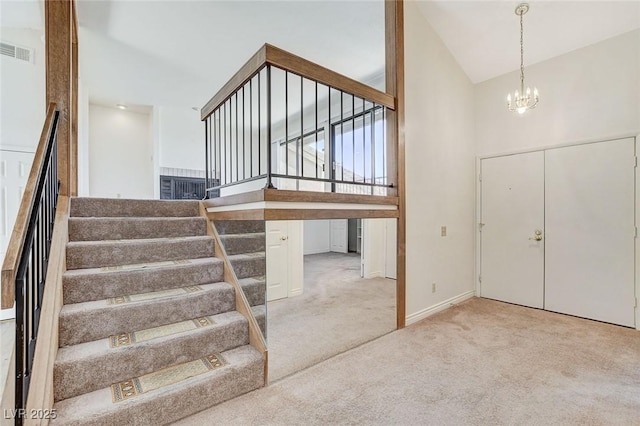 532 Greenbriar Pl, Boulder City, NV 89005 - foyer entrance featuring high vaulted ceiling, stairs, a chandelier, and carpet flooring