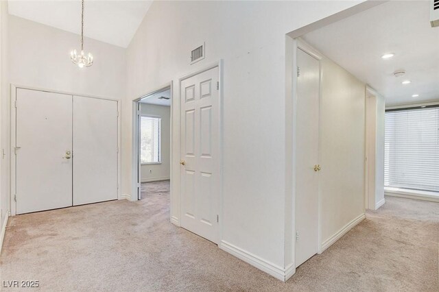 532 Greenbriar Pl, Boulder City, NV 89005 - entryway with light carpet, a chandelier, and high vaulted ceiling