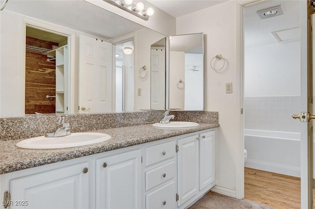 532 Greenbriar Pl, Boulder City, NV 89005 - full bathroom featuring double vanity, a tub to relax in, and wood finished floors