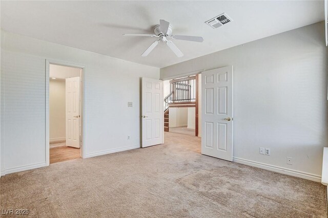 532 Greenbriar Pl, Boulder City, NV 89005 - unfurnished bedroom with light carpet, ensuite bath, and a ceiling fan