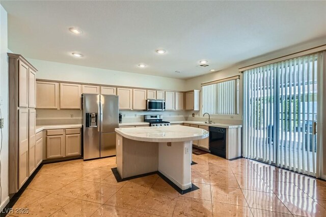 89 Autumn Day St, Henderson, NV 89012 - kitchen with stainless steel appliances, light countertops, a center island, recessed lighting, and light tile patterned flooring