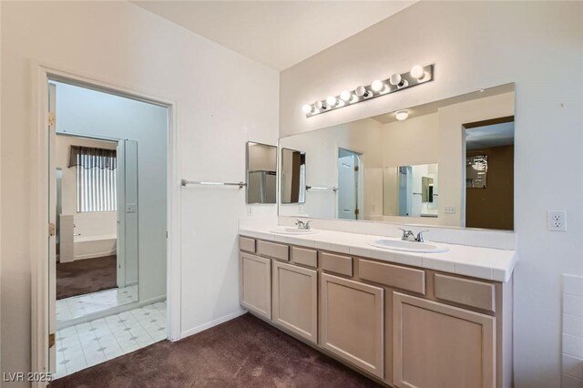 89 Autumn Day St, Henderson, NV 89012 - full bath with a tub to relax in, double vanity, and baseboards