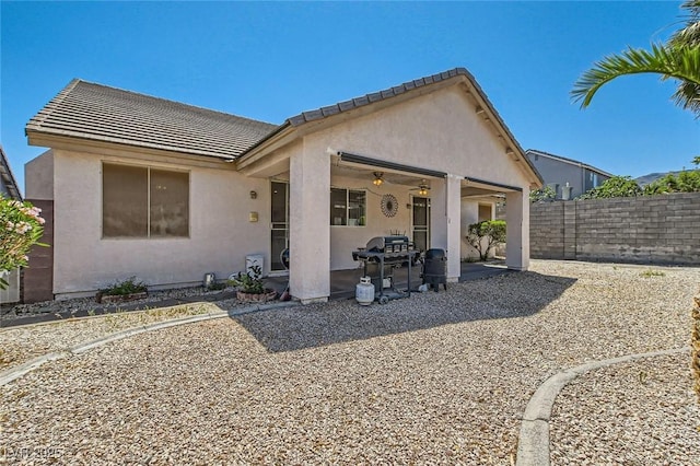 89 Autumn Day St, Henderson, NV 89012 - rear view of house with stucco siding, a patio area, a ceiling fan, a fenced backyard, and a tile roof