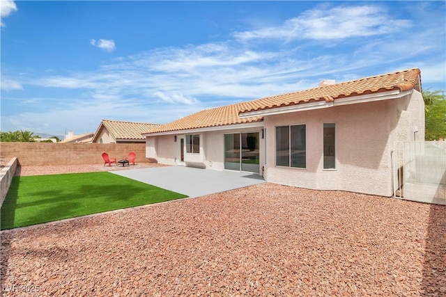 3109 Siena Cir, Las Vegas, NV 89128 - rear view of house with stucco siding, a tile roof, a fenced backyard, and a patio