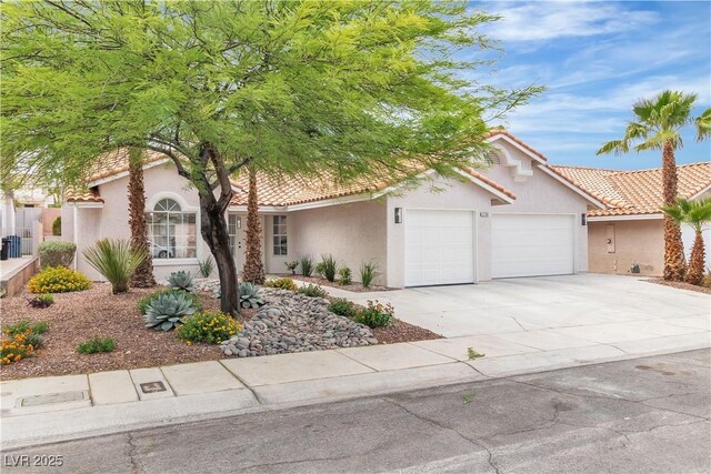 3109 Siena Cir, Las Vegas, NV 89128 - view of front of house with an attached garage, stucco siding, driveway, and a tile roof