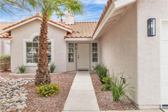 3109 Siena Cir, Las Vegas, NV 89128 - doorway to property with stucco siding and a tiled roof