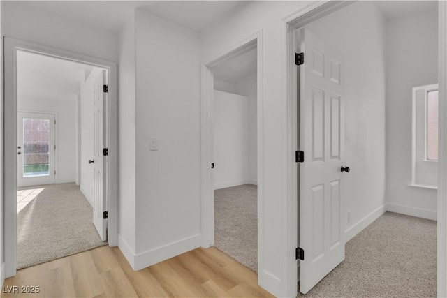3109 Siena Cir, Las Vegas, NV 89128 - corridor featuring baseboards, light carpet, and light wood-style flooring