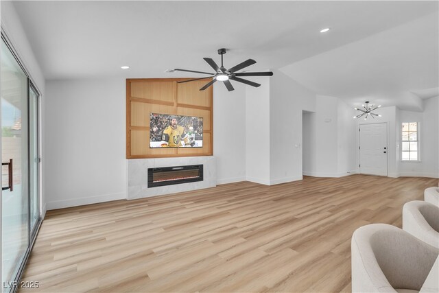 3109 Siena Cir, Las Vegas, NV 89128 - living room with a glass covered fireplace, a chandelier, baseboards, light wood-style flooring, and recessed lighting