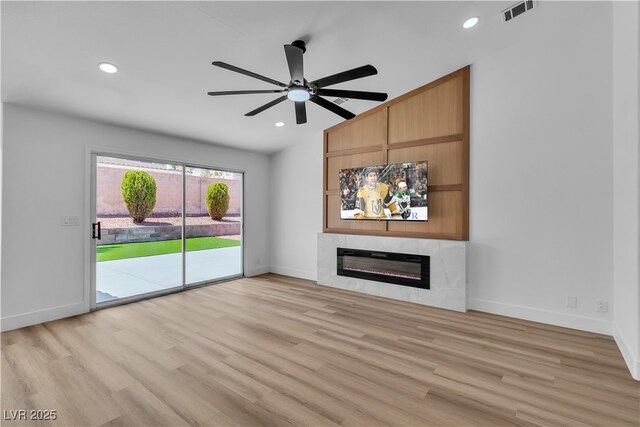 3109 Siena Cir, Las Vegas, NV 89128 - unfurnished living room featuring ceiling fan, light wood-style floors, a glass covered fireplace, baseboards, and recessed lighting