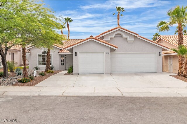 3109 Siena Cir, Las Vegas, NV 89128 - mediterranean / spanish-style house featuring a garage, stucco siding, concrete driveway, and a tiled roof