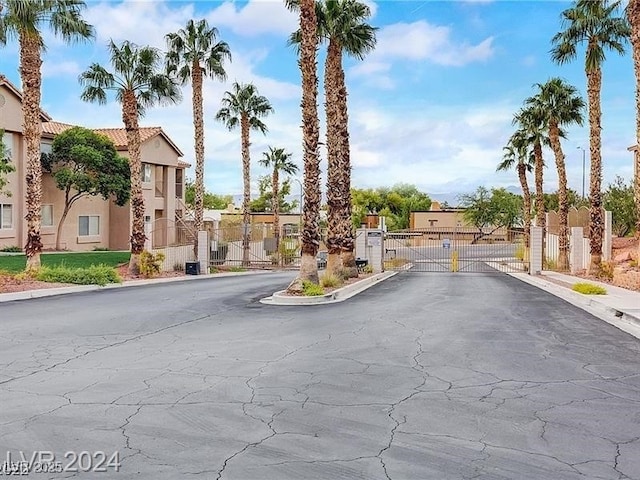 2110 Los Feliz St Unit 1066, Las Vegas, NV 89156 - view of asphalt street featuring a gate, a residential view, a gated entry, and curbs