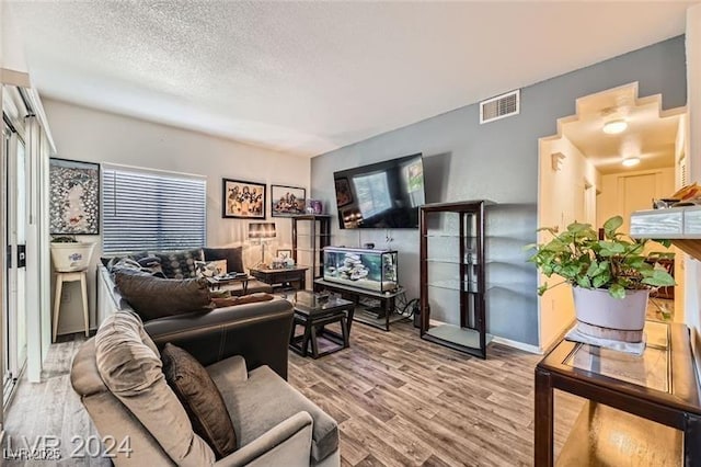 2110 Los Feliz St Unit 1066, Las Vegas, NV 89156 - living area featuring wood finished floors and a textured ceiling